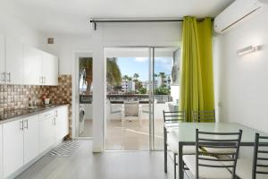 a kitchen and dining room with a table and chairs at Nice Apartment 1210 In Central Area in San Bartolomé