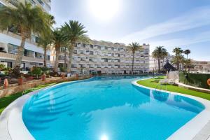a large swimming pool in front of a hotel at Nice Apartment 1210 In Central Area in San Bartolomé