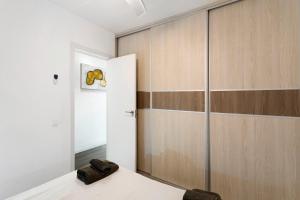 a room with a sliding glass door and a closet at Nice Apartment 1210 In Central Area in San Bartolomé +17 photos