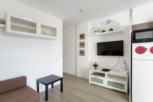 a living room with a couch and a tv at Nice Apartment 1210 In Central Area in San Bartolomé
