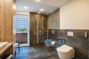 a bathroom with a toilet and a shower at Dalblick in Oberharmersbach +22 photos