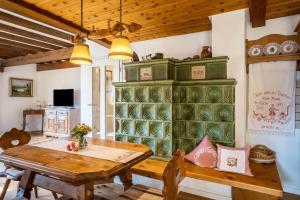 a dining room with a table and a green cabinet at Dalblick in Oberharmersbach