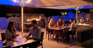 people sitting at tables in a restaurant at night at Aberdunant Hall, Snowdonia in Porthmadog
