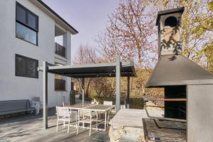 a patio with a table and an outdoor oven at Villa Marel in Cerdillo
