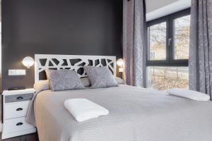 a bedroom with a white bed and a window at Villa Marel in Cerdillo