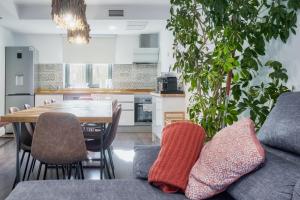a kitchen and dining room with a couch and a table at Villa Marel in Cerdillo