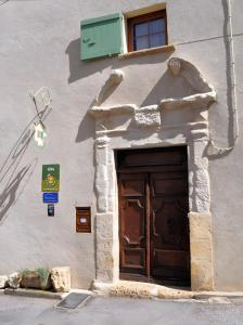 a building with a large wooden door on it at Gîte De Diane in Allemagne-en-Provence