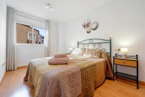 a bedroom with a bed and a window at Canana De Vega in Flix