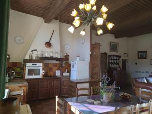 a kitchen and living room with a chandelier at Gîte De Diane in Allemagne-en-Provence