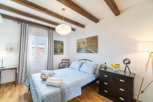 a bedroom with a bed and a dresser at Contessa di Corfu ii in Corfu