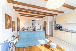 a kitchen with a blue couch in the middle of a room at Contessa di Corfu ii in Corfu