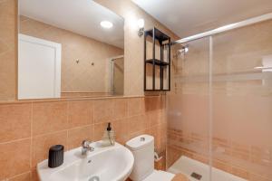 a bathroom with a sink and a toilet and a shower at Vv Estrella in Puerto de Mogán +23 photos