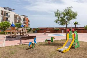 a playground with a slide in a park at Cubelles mar in Cubelles