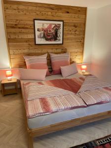a bedroom with a large bed with two lamps on tables at Ferienparadies Bodensee Fewo1 in Owingen +30 photos