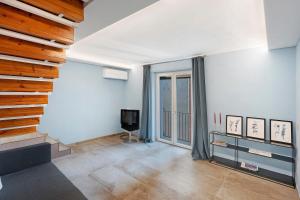 a living room with a tv and a large window at Civico 32 in Salerno