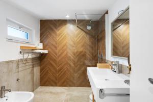 a bathroom with two sinks and a wooden wall at Civico 32 in Salerno +18 photos