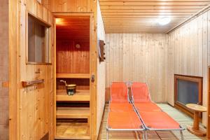 an empty sauna with orange chairs in a room at Blütenzauber in Todtnau