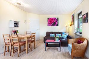 a living room with a table and a couch at Blütenzauber in Todtnau