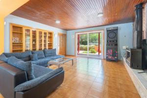 a living room with a blue couch and a tv at Ilusion in Olocau