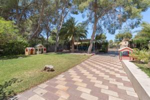 a walkway in a park with a playground at Ilusion in Olocau