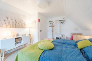 a bedroom with a bed with a yellow pillow on it at Onkel Franz in Ohlsbach