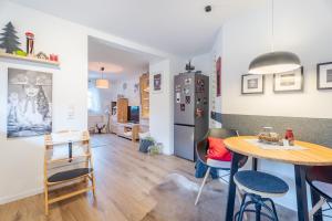 a kitchen and dining room with a table and a refrigerator at Onkel Franz in Ohlsbach