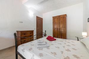 a bedroom with a bed with a red towel on it at Villa Eleonora Residence App to 4 in Capoterra