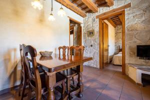 a dining room with a wooden table and chairs at El Clos 1 in Conesa