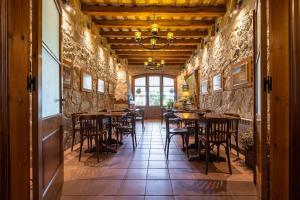a restaurant with tables and chairs in a room at El Clos 1 in Conesa