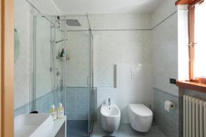 a bathroom with a shower and a toilet and a sink at Panorama Apartment 180 mq in Nago-Torbole +34 photos