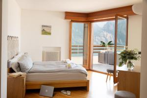 a bedroom with a bed and a large window at Panorama Apartment 180 mq in Nago-Torbole