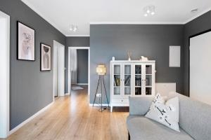 a living room with gray walls and a couch at B5fewo in Bad Bellingen