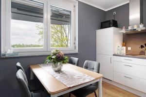 a kitchen and dining room with a table and chairs at B5fewo in Bad Bellingen +18 photos