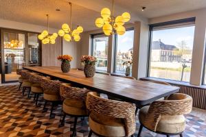 a large dining room with a long table and chairs at Hotel de Zon - Brasserie Bresson by Flow in Ommen