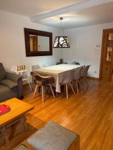 a living room with a dining room table and chairs at Casa Arguis in Eriste