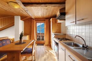 a kitchen with a sink and a stove top oven at Jelerhof in Gsies