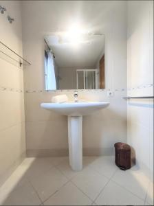 a bathroom with a white sink and a mirror at Casa Arguis in Eriste +34 photos
