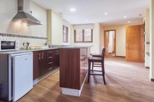 a kitchen with a counter and a stove top oven at Valle del Ibias - Segundo Izquierda in Cecos