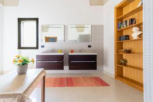 a bathroom with a sink and a mirror at Casa Pizzicchia in Muro Leccese +21 photos