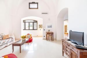 a living room with a tv and a couch at Casa Pizzicchia in Muro Leccese