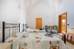 a bedroom with a bed with a blanket on it at Casa Pizzicchia in Muro Leccese