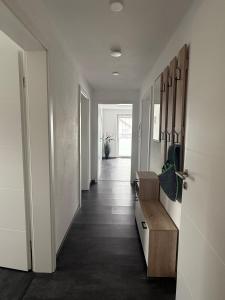 a hallway of a home with white walls and wood floors at Ferienwohnung S Keller in Plankenfels