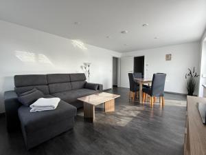 a living room with a couch and a table at Ferienwohnung S Keller in Plankenfels