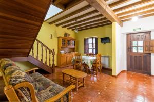 a living room with a couch and a table at Casa Rural Perullé in San Vicente de la Barquera