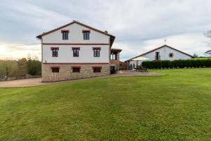 a large yard with a house in the background at Casa Rural Perullé in San Vicente de la Barquera
