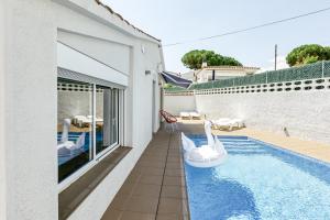 a swimming pool with swans in a house at Villa La Vall in L'Escala