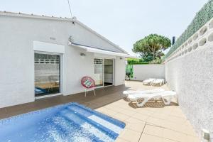a swimming pool in the backyard of a house at Villa La Vall in L'Escala