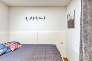 a bedroom with a bed with birds on the wall at Villa La Vall in L'Escala +16 photos