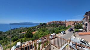 a view of a street with cars parked on a hill at Appartamento Bellavista in Capoliveri