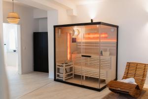 a glass cabinet in a room with a chair at Barrierefreies Loft Apartment in Dessau